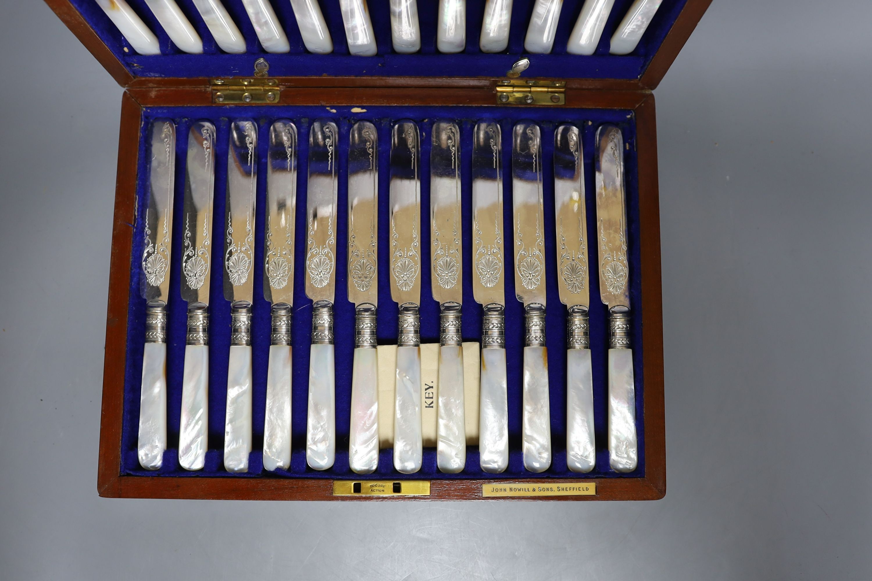 A cased set of silver handled pistol knives and a cased set of mother-of-pearl fruit knives and forks